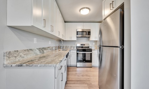 a kitchen with white cabinets