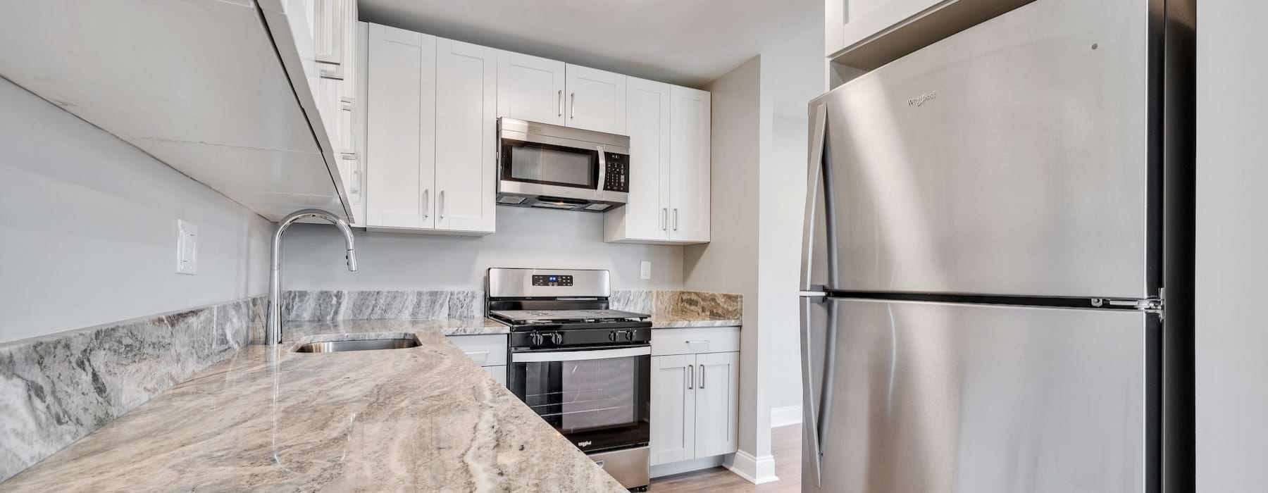 a kitchen with white cabinets