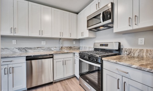 a kitchen with grey cabinets